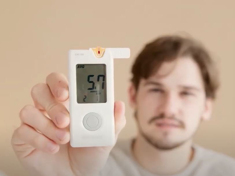 young man showing his glucose level